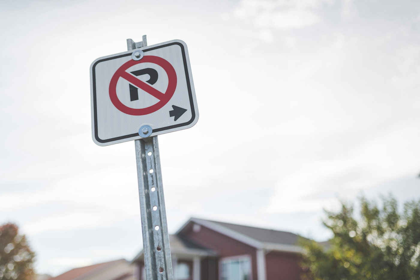 a-no-parking-sign-in-front-of-a-house